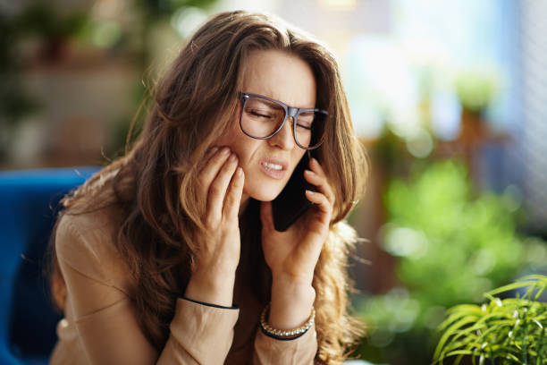 A woman holding her jaw in pain due to a toothache